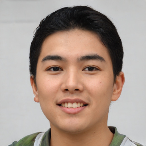 Joyful asian young-adult male with short  black hair and brown eyes