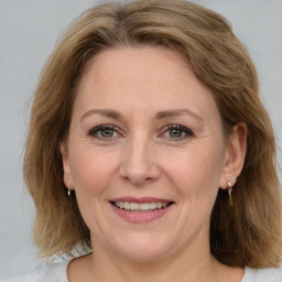 Joyful white adult female with medium  brown hair and grey eyes