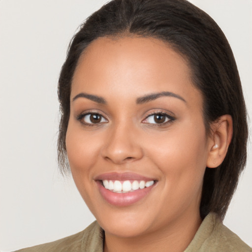 Joyful latino young-adult female with long  brown hair and brown eyes