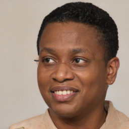 Joyful black young-adult male with short  black hair and brown eyes