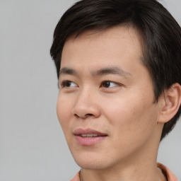 Joyful asian young-adult male with short  brown hair and brown eyes