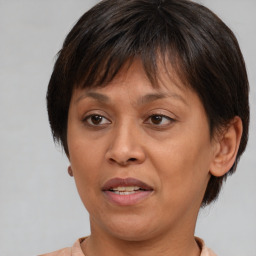 Joyful white adult female with medium  brown hair and brown eyes