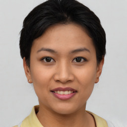 Joyful asian young-adult female with short  brown hair and brown eyes