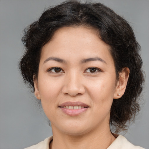 Joyful white young-adult female with medium  brown hair and brown eyes