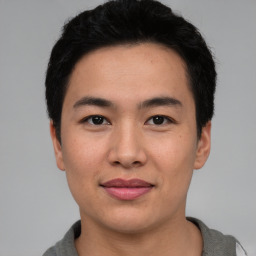 Joyful asian young-adult male with short  black hair and brown eyes