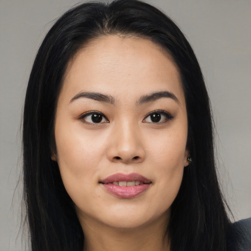 Joyful asian young-adult female with long  black hair and brown eyes