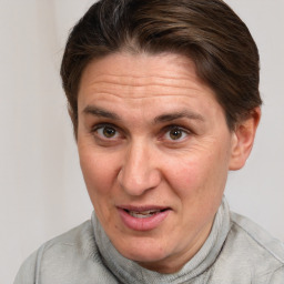 Joyful white adult female with short  brown hair and grey eyes