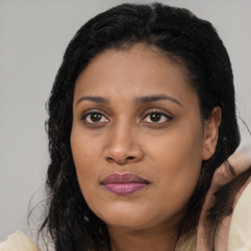 Joyful black young-adult female with medium  brown hair and brown eyes