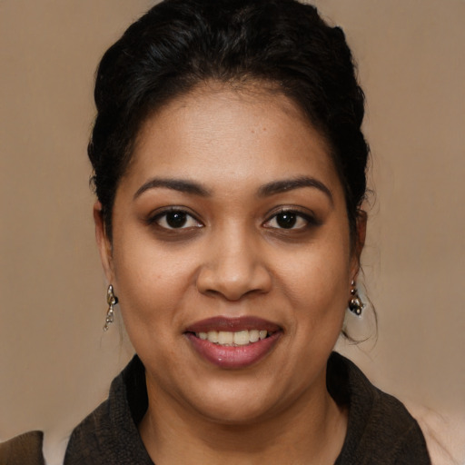 Joyful latino young-adult female with long  black hair and brown eyes