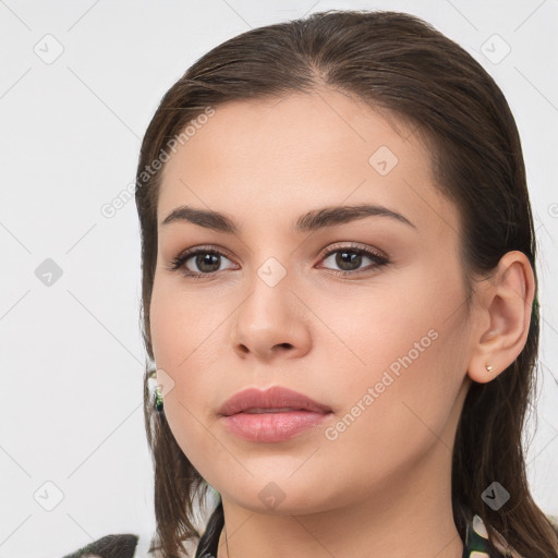 Neutral white young-adult female with long  brown hair and brown eyes