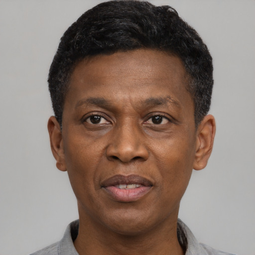 Joyful black adult male with short  black hair and brown eyes