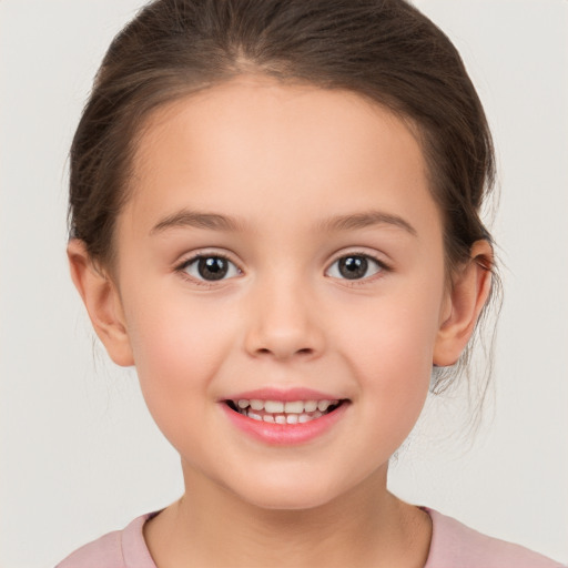 Joyful white child female with medium  brown hair and brown eyes