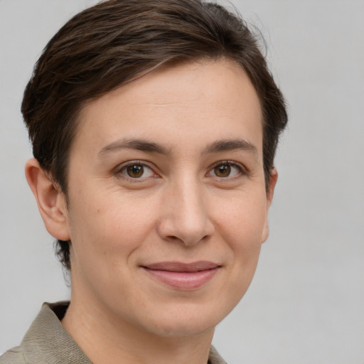 Joyful white young-adult female with short  brown hair and grey eyes