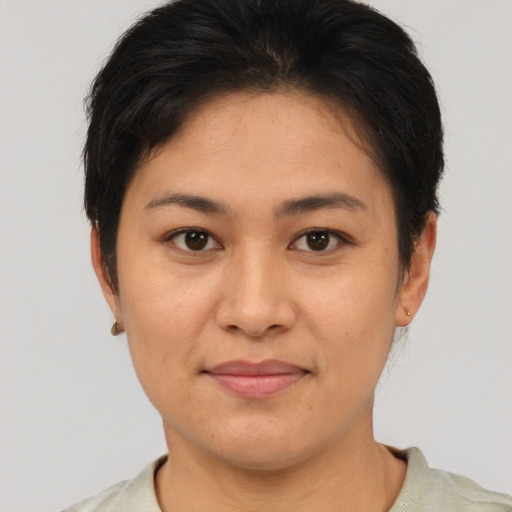 Joyful asian young-adult female with short  brown hair and brown eyes