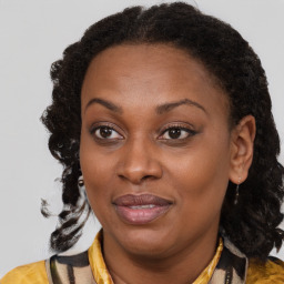 Joyful black adult female with medium  brown hair and brown eyes