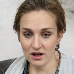 Joyful white adult female with medium  brown hair and brown eyes