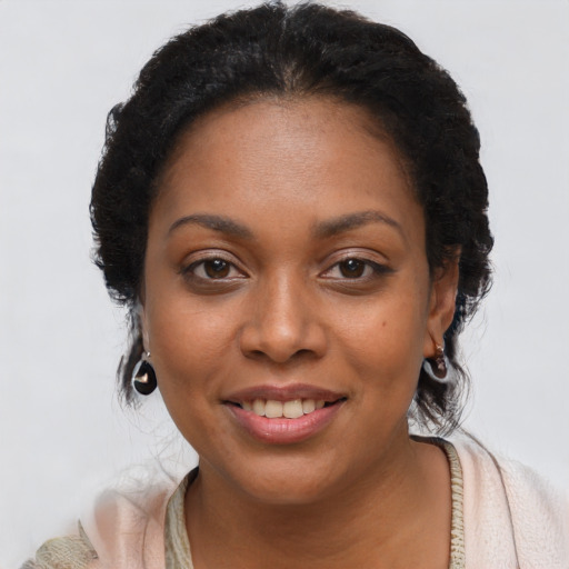 Joyful black young-adult female with short  brown hair and brown eyes