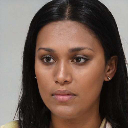 Neutral black young-adult female with long  brown hair and brown eyes
