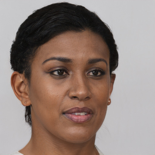 Joyful black young-adult female with short  brown hair and brown eyes