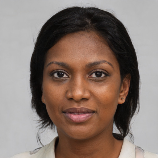 Joyful black young-adult female with medium  brown hair and brown eyes