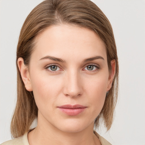 Joyful white young-adult female with medium  brown hair and grey eyes