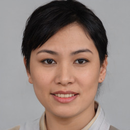 Joyful asian young-adult female with medium  brown hair and brown eyes