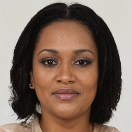 Joyful black adult female with medium  black hair and brown eyes