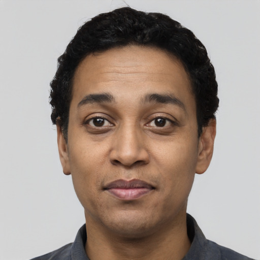 Joyful latino adult male with short  black hair and brown eyes