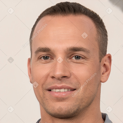 Joyful white young-adult male with short  brown hair and brown eyes