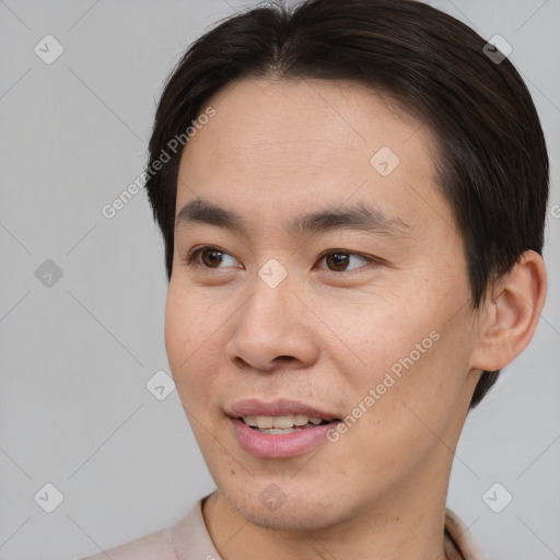 Joyful asian young-adult male with short  brown hair and brown eyes