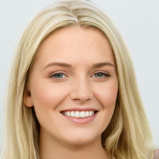 Joyful white young-adult female with long  brown hair and blue eyes