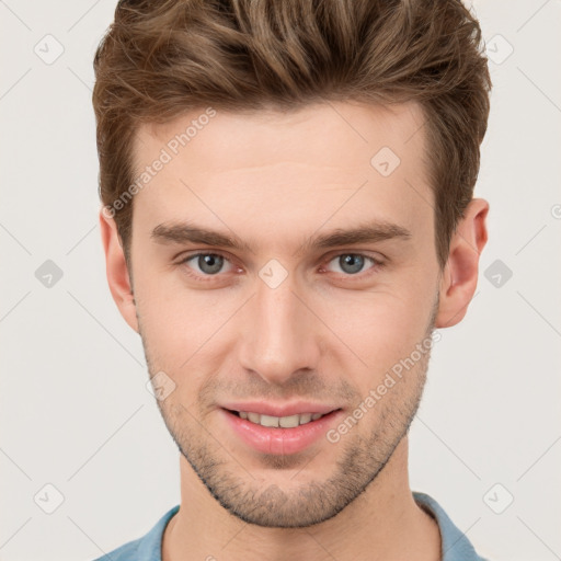 Joyful white young-adult male with short  brown hair and grey eyes