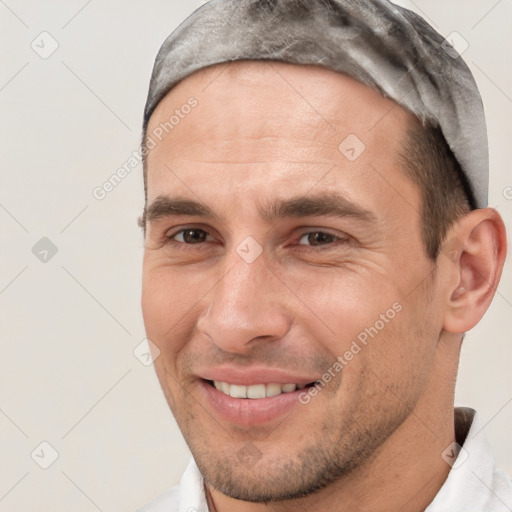 Joyful white adult male with short  brown hair and brown eyes