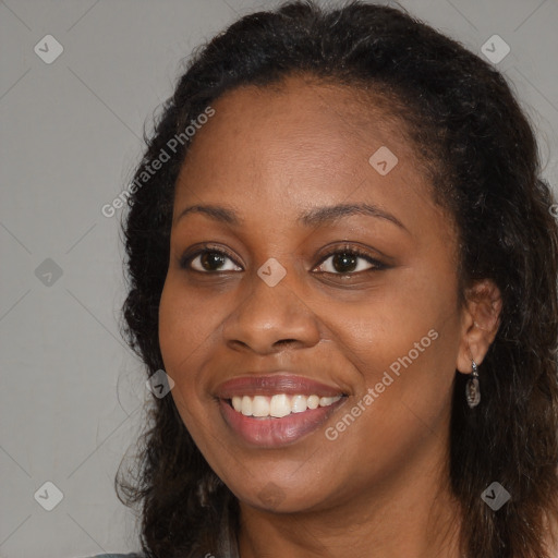 Joyful black young-adult female with long  brown hair and brown eyes