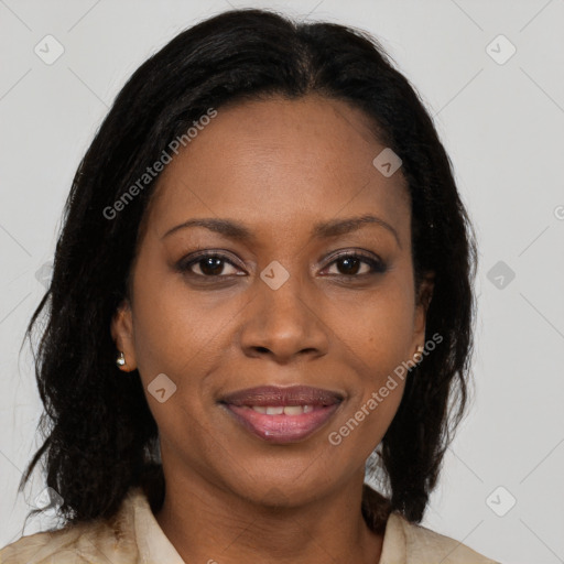 Joyful black adult female with long  brown hair and brown eyes