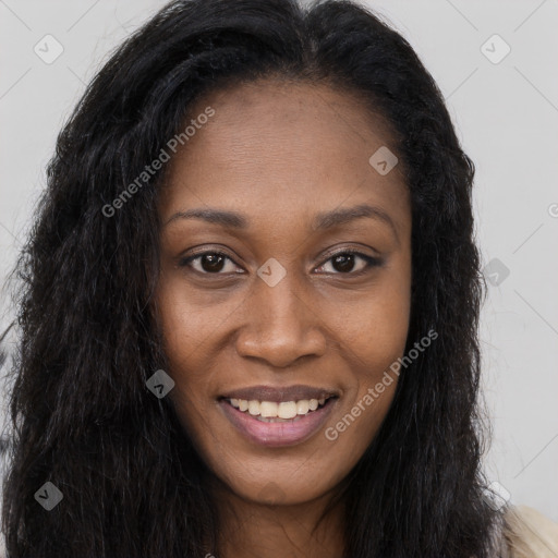 Joyful black young-adult female with long  brown hair and brown eyes