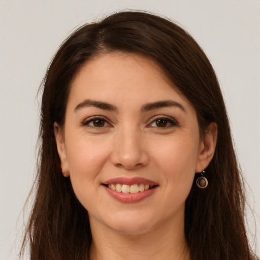 Joyful white young-adult female with long  brown hair and brown eyes