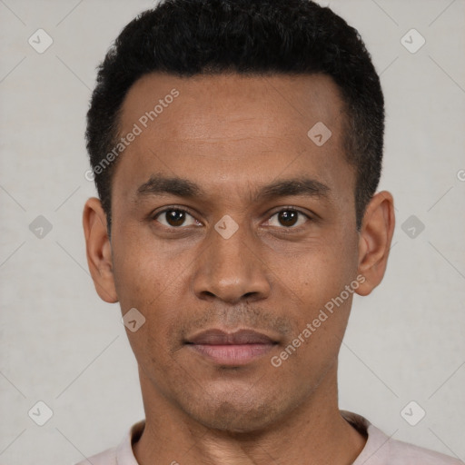 Joyful latino young-adult male with short  black hair and brown eyes