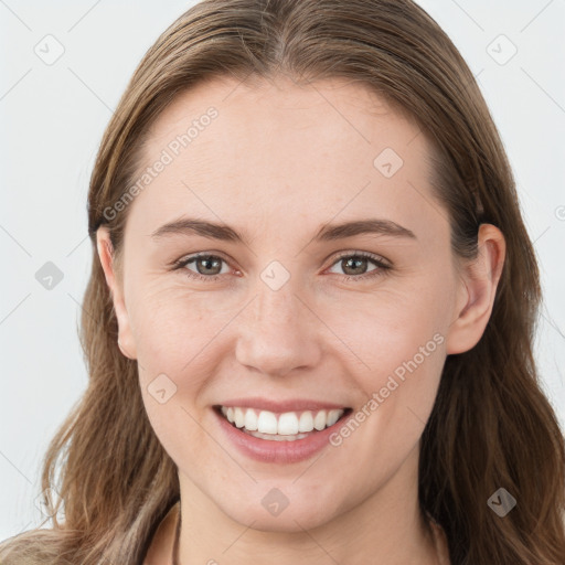 Joyful white young-adult female with long  brown hair and blue eyes