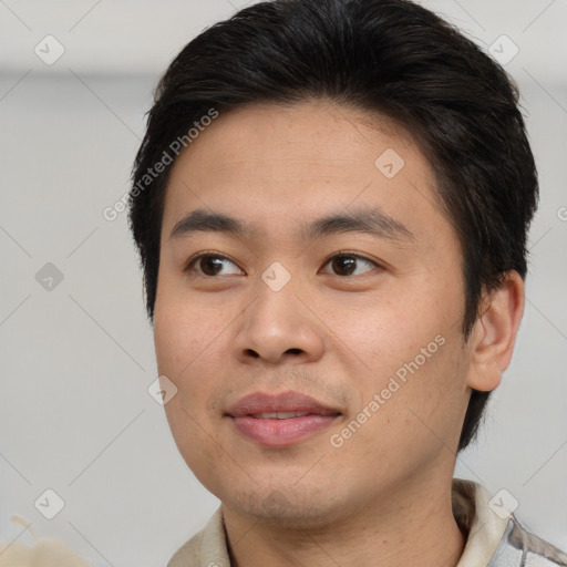 Joyful asian young-adult male with short  brown hair and brown eyes