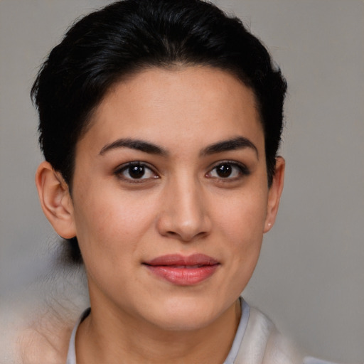 Joyful latino young-adult female with short  brown hair and brown eyes