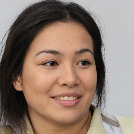 Joyful asian young-adult female with medium  brown hair and brown eyes