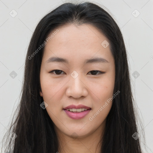 Joyful asian young-adult female with long  brown hair and brown eyes