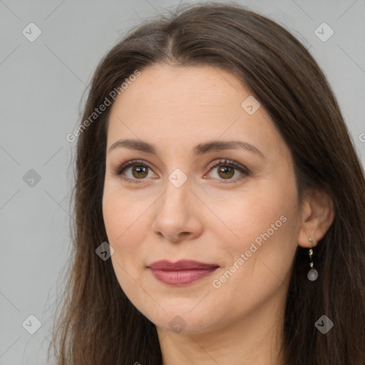 Joyful white adult female with long  brown hair and brown eyes