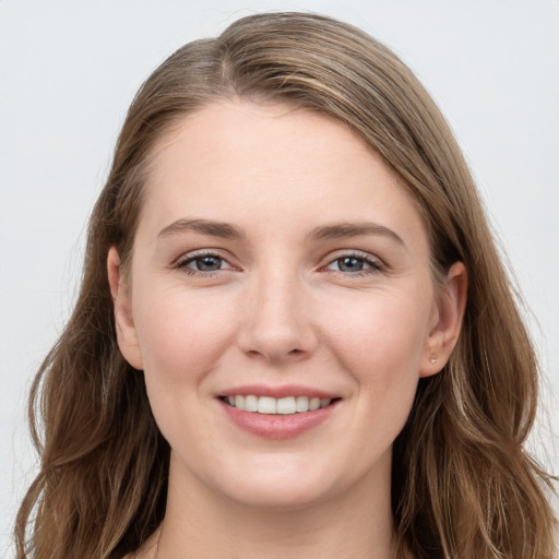 Joyful white young-adult female with long  brown hair and grey eyes