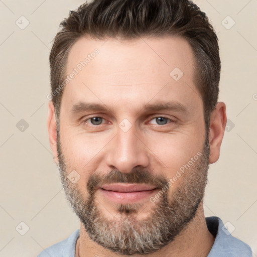 Joyful white adult male with short  brown hair and brown eyes