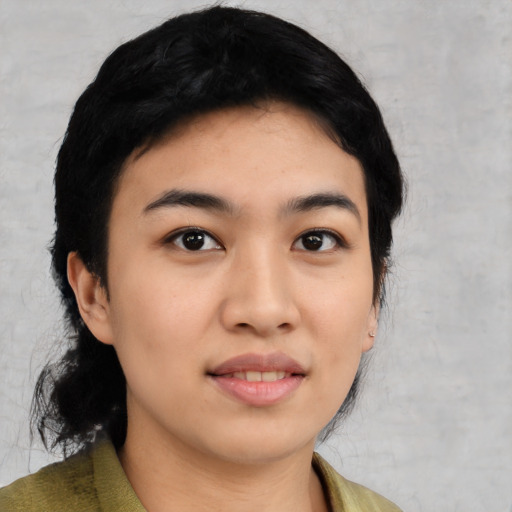 Joyful latino young-adult female with medium  black hair and brown eyes