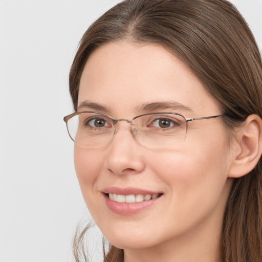 Joyful white adult female with long  brown hair and brown eyes