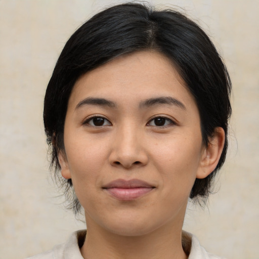 Joyful asian young-adult female with medium  brown hair and brown eyes