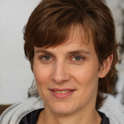 Joyful white adult female with medium  brown hair and grey eyes